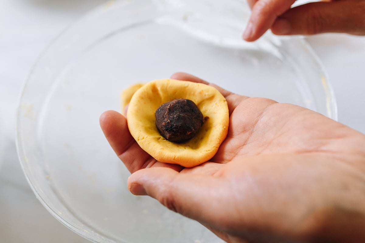 red bean filling in pumpkin cake dough