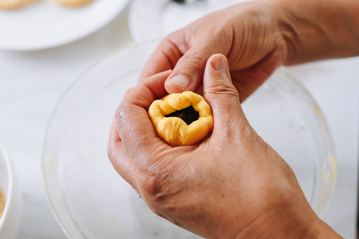 closing pumpkin dough over filling