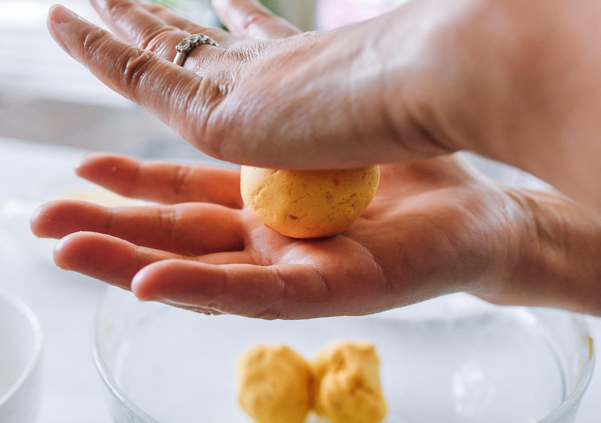 rolling pumpkin cake dough between hands into a ball