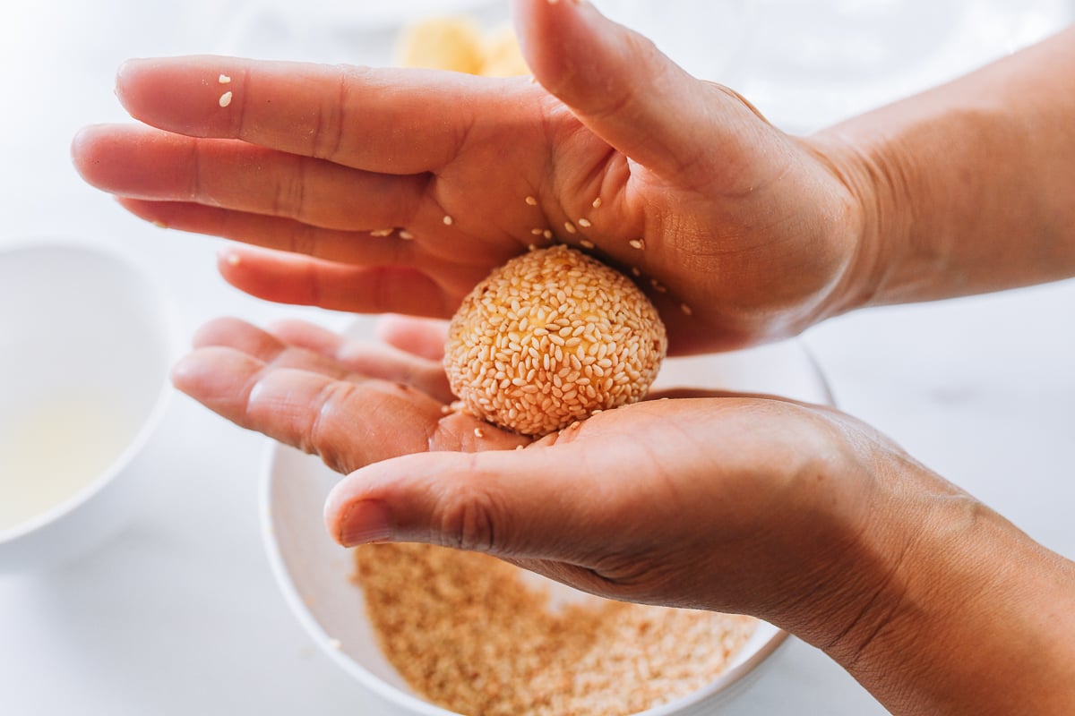 rolling sesame seeds into dough
