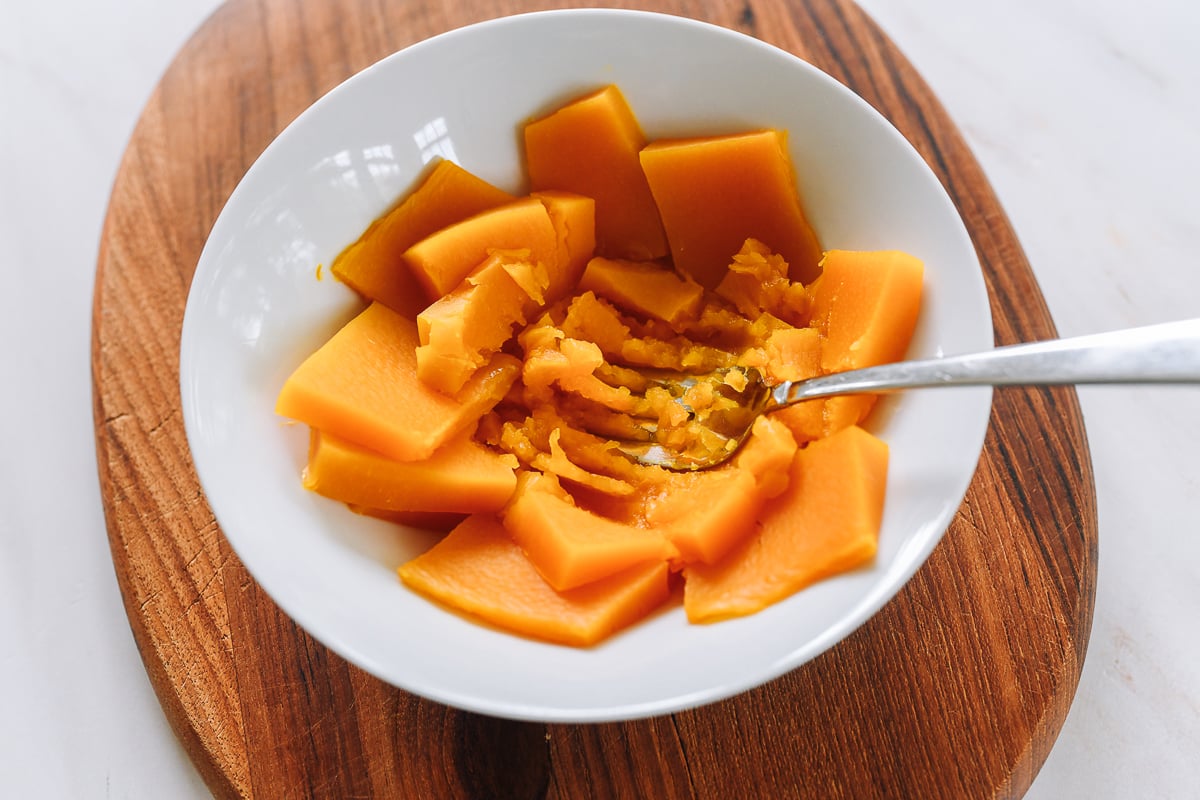 mashing steamed pumpkin with fork