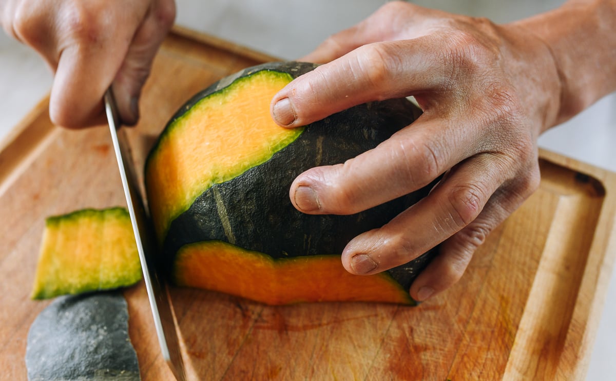 using a knife to peel kabocha