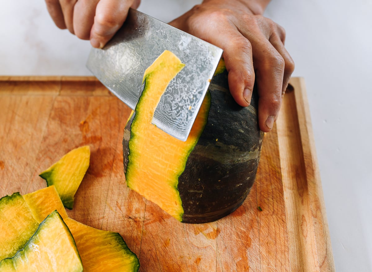 Cutting green skin off of orange kabocha squash