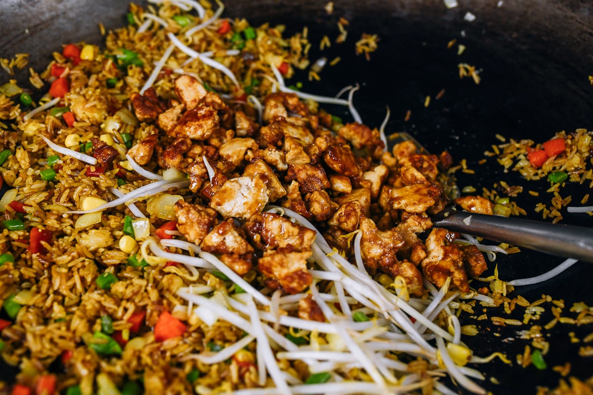 adding seasoned tofu to fried rice