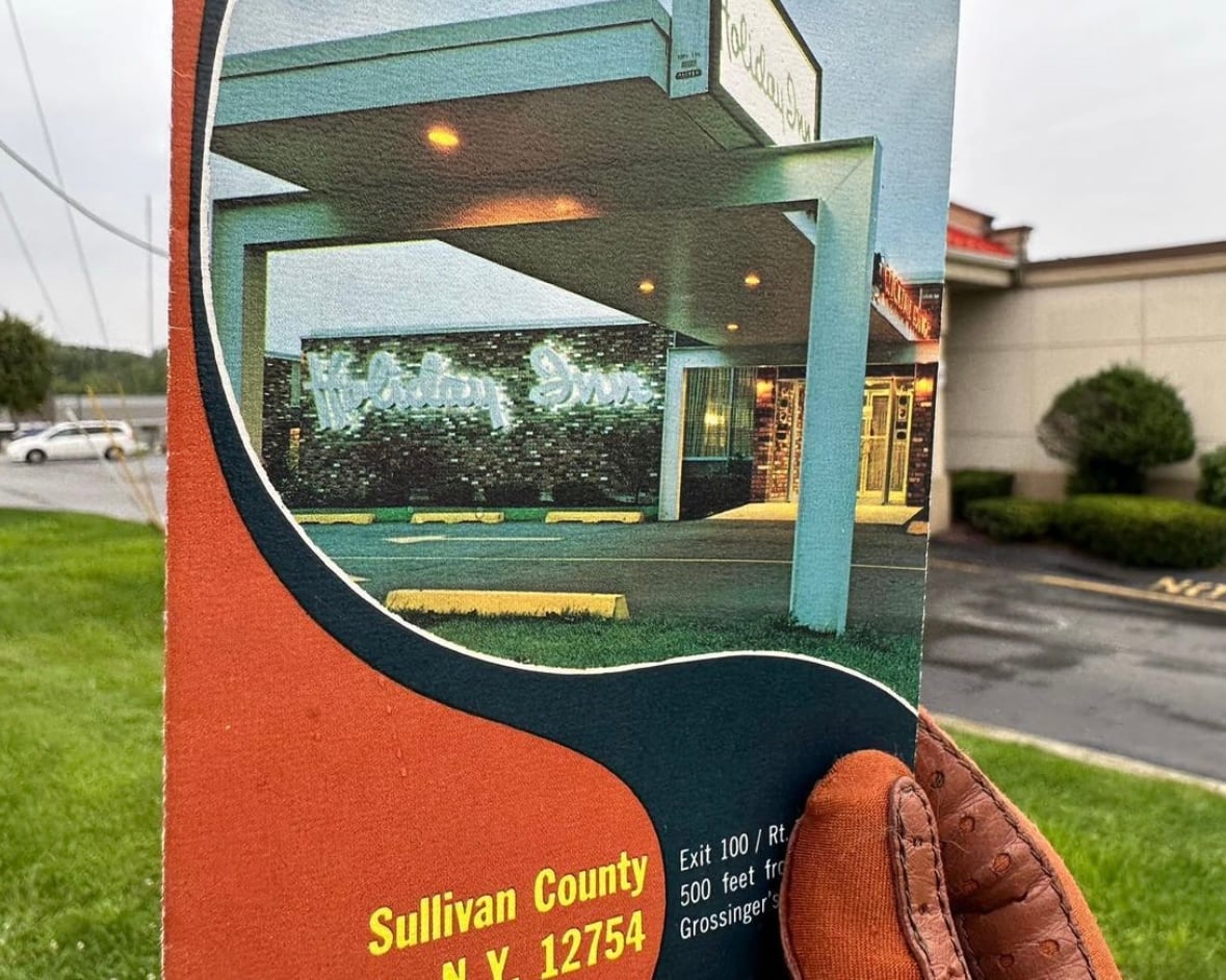 Holiday Inn Brochure in front of new derelict location in Liberty New York