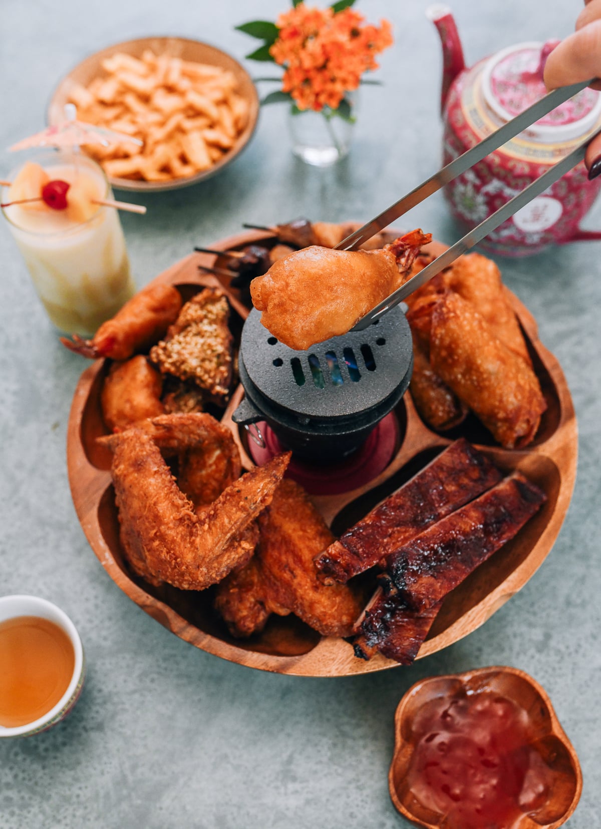 Toasting fantail shrimp over sterno on pupu platter