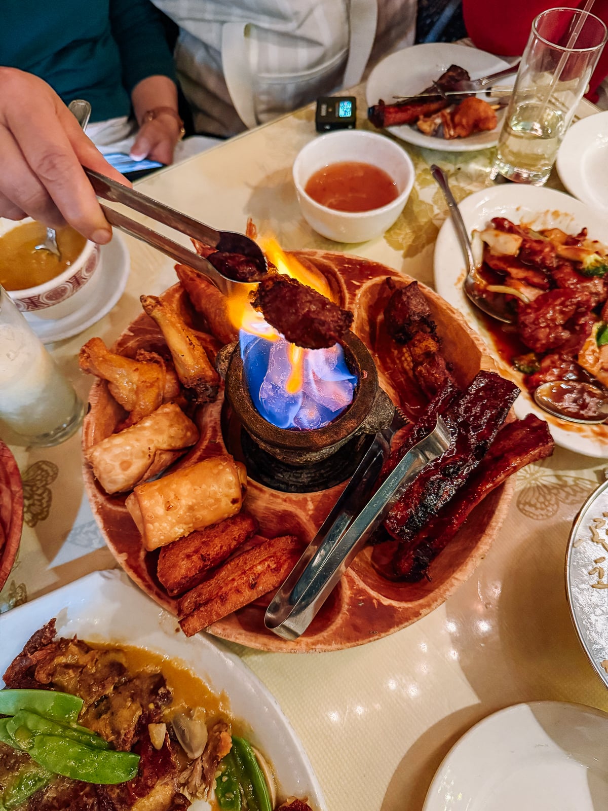 toasting food over flame on pupu platter
