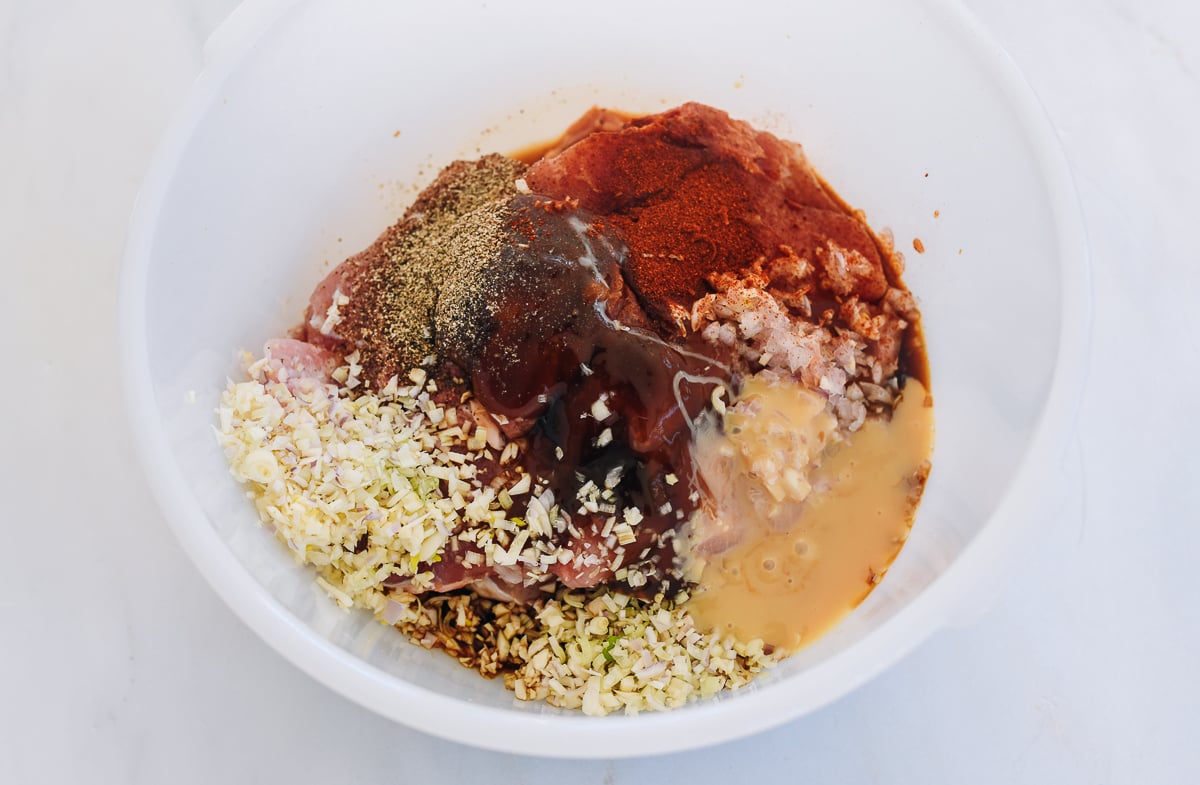 pork chops in bowl with marinade ingredients