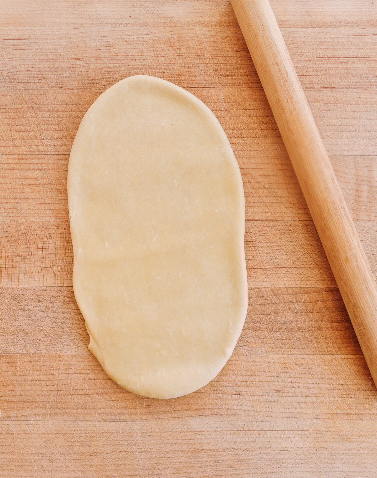 rolling out dough sheet with Chinese rolling pin