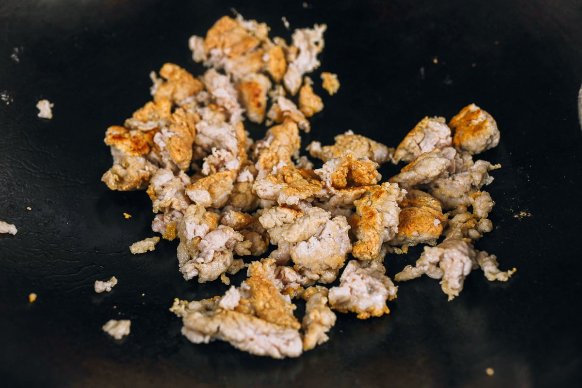 seared ground chicken chunks in wok