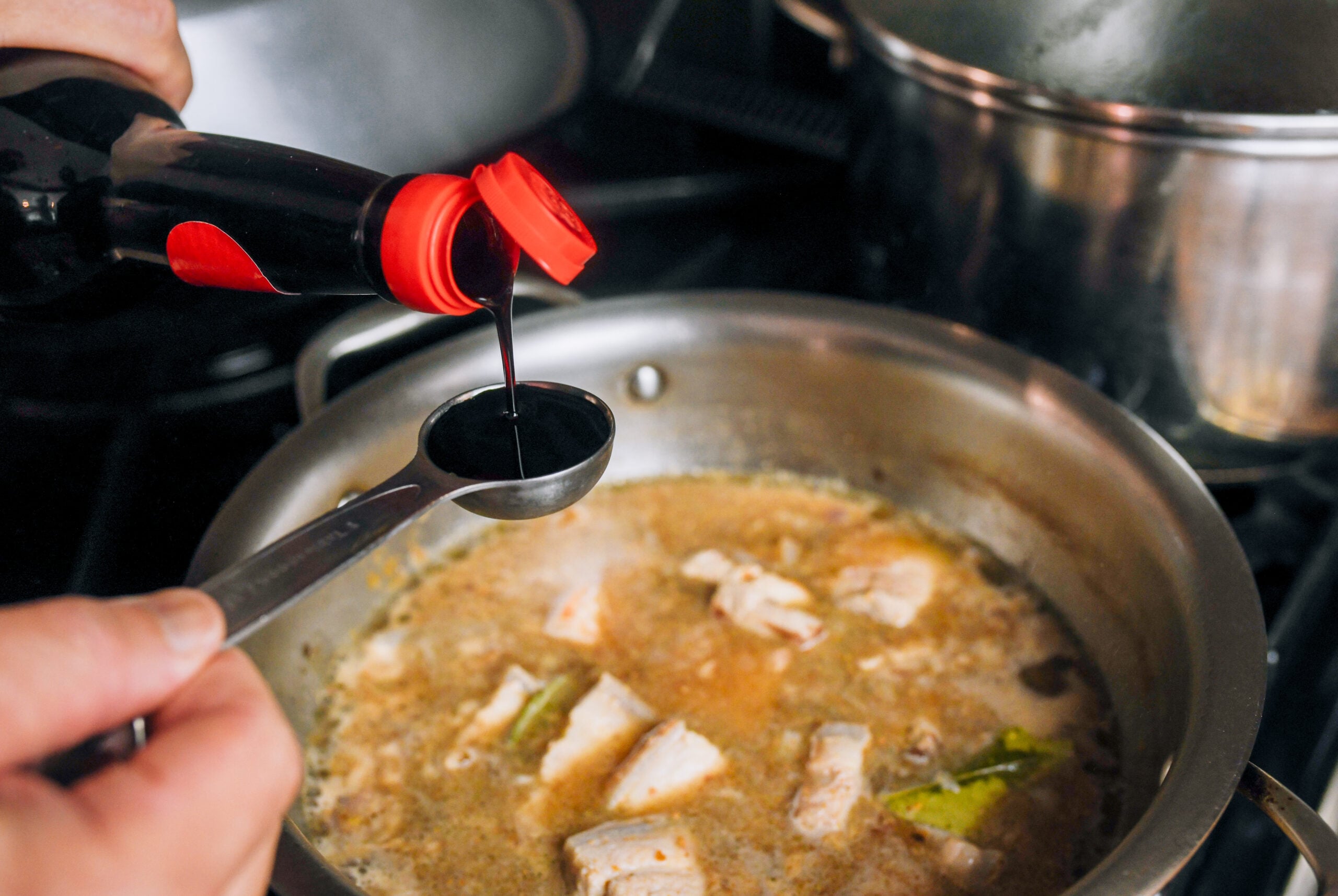 adding kecap manis to pork belly