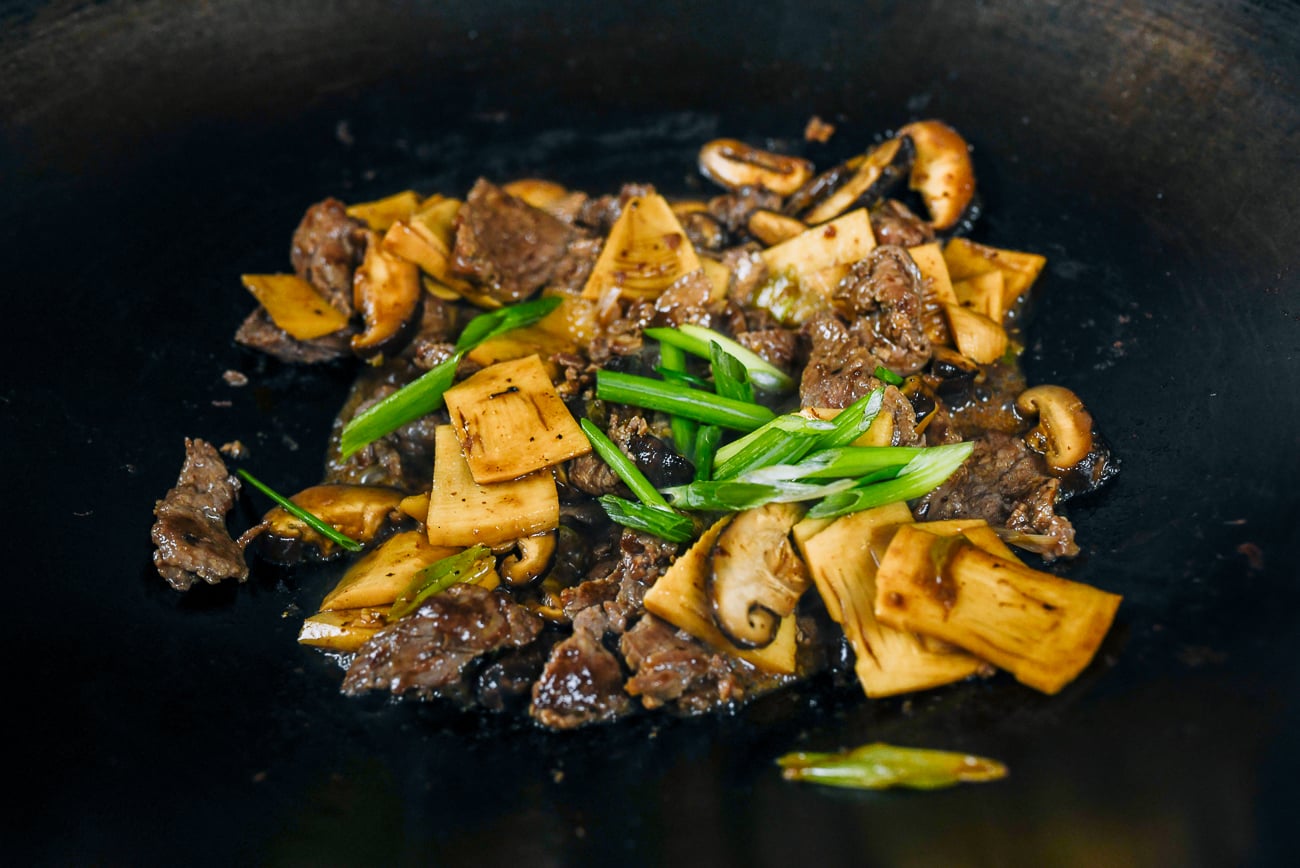 scallions added to beef with mushrooms and bamboo