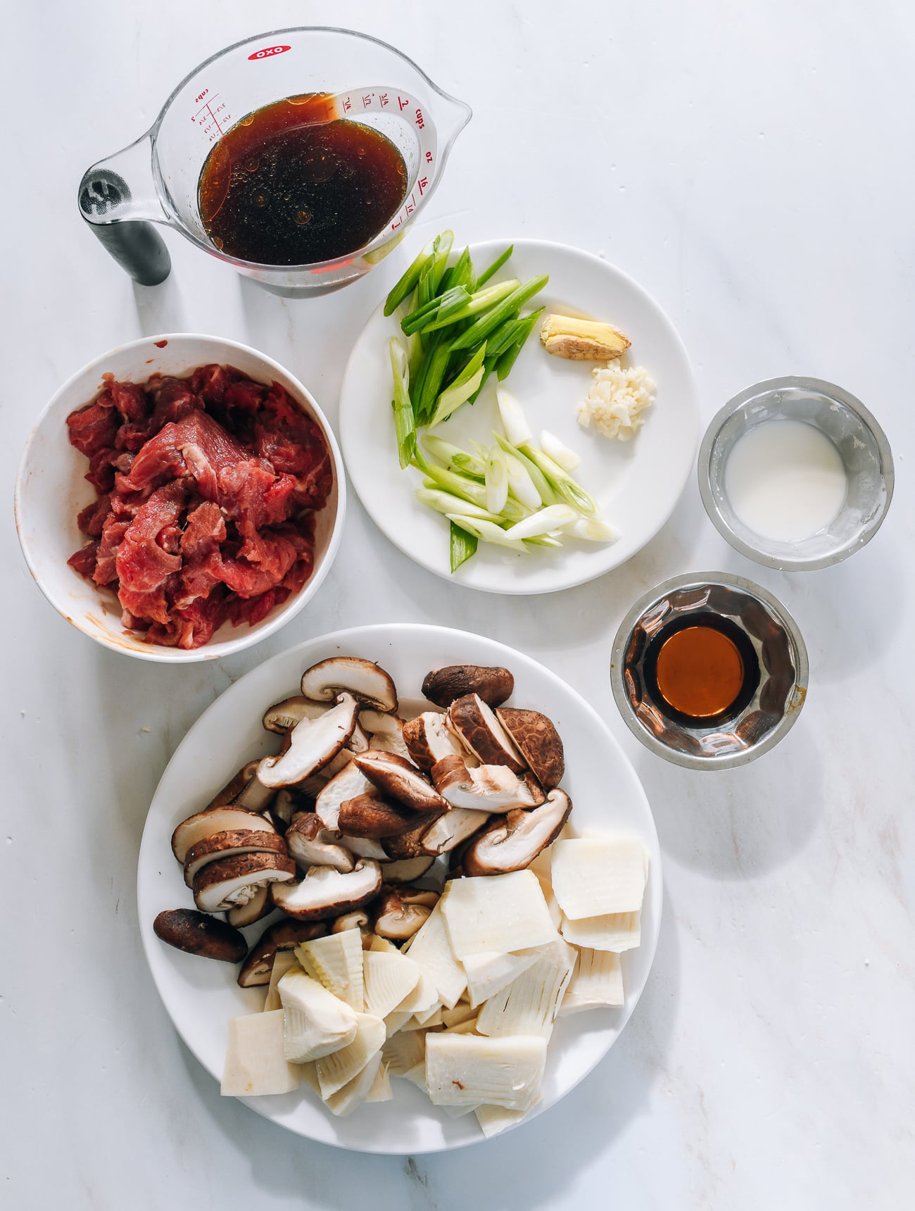 ingredients laid out for beef with bamboo shoots and mushrooms