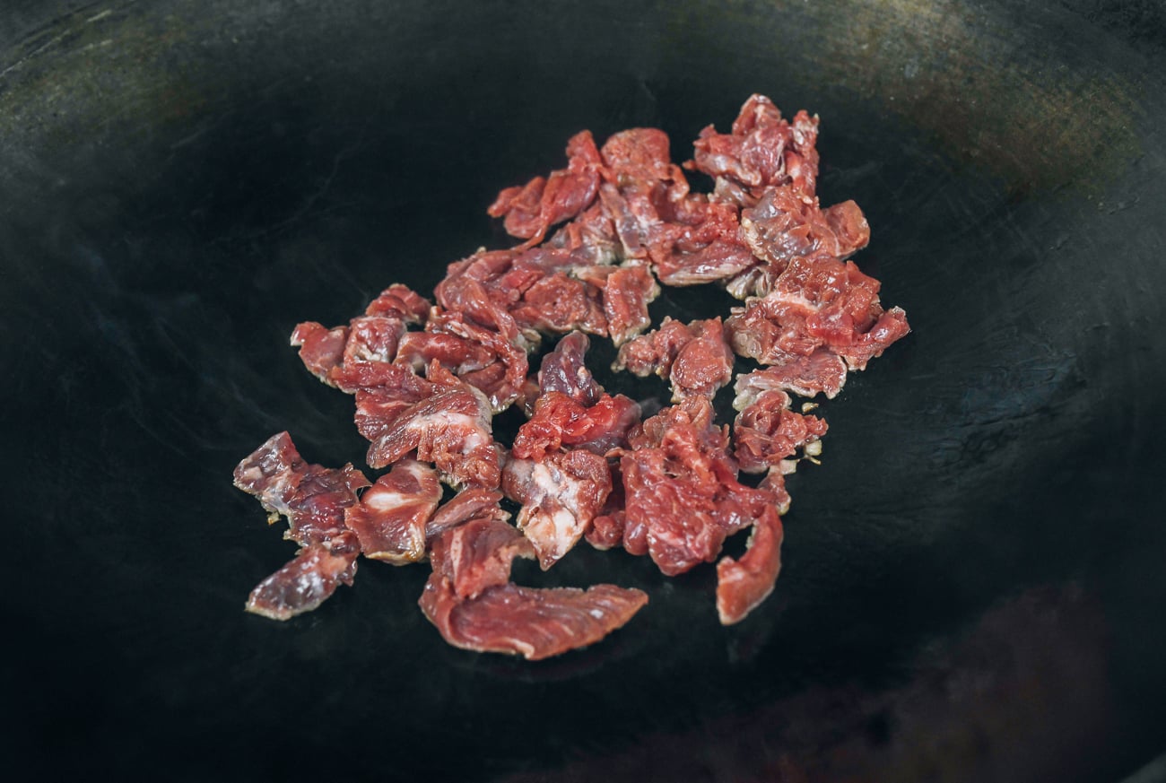 sliced beef searing in wok