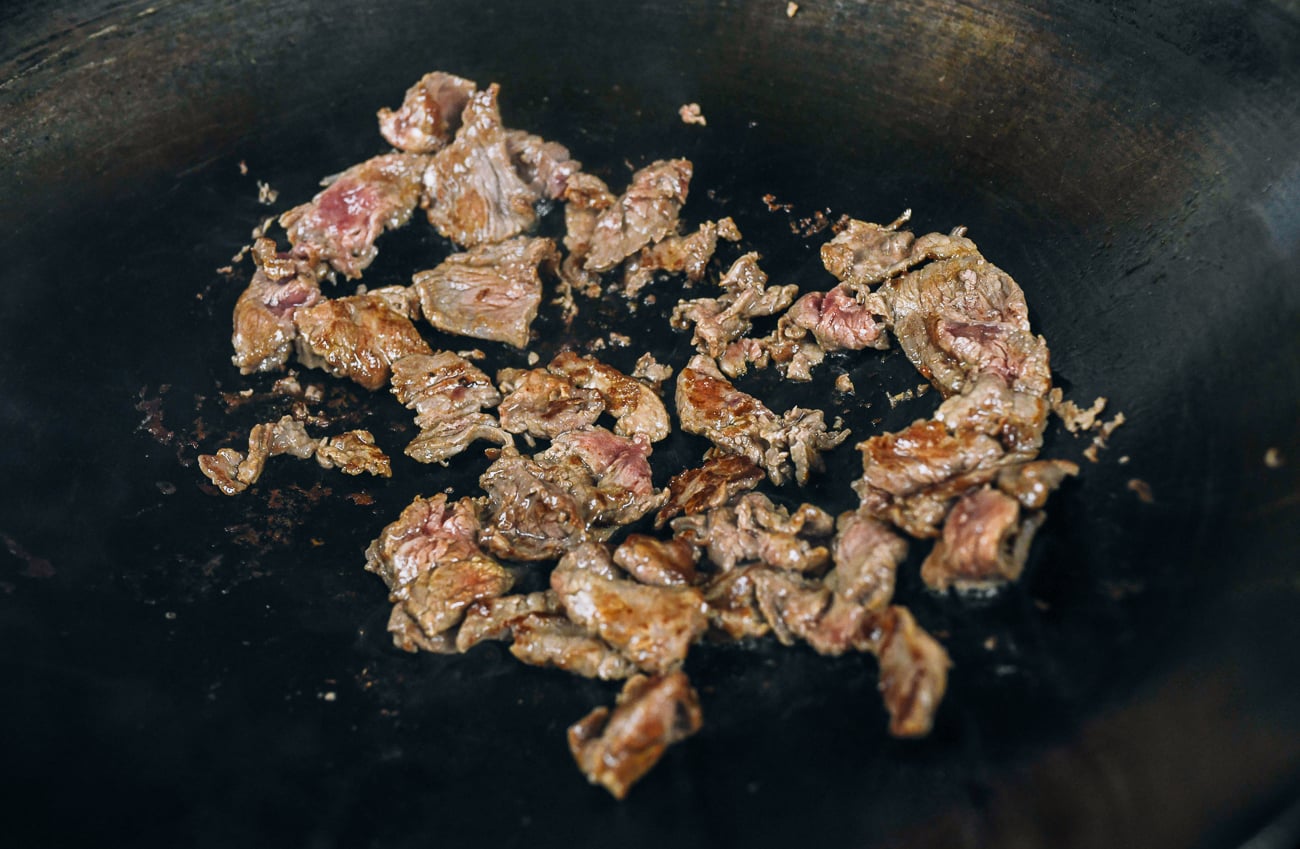 seared sliced beef in wok