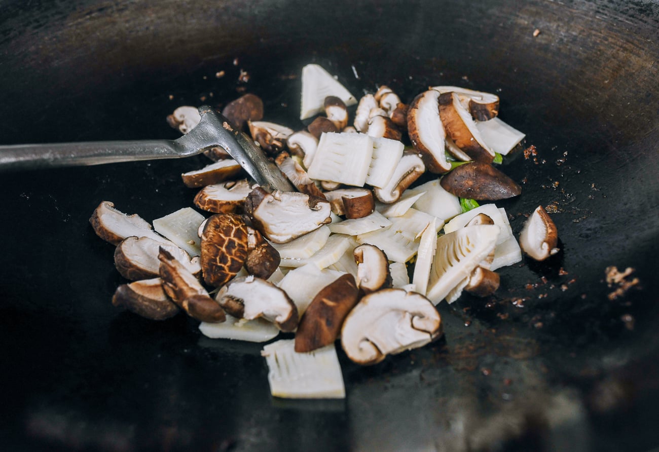 fresh shiitake mushrooms and bamboo shoots in wok