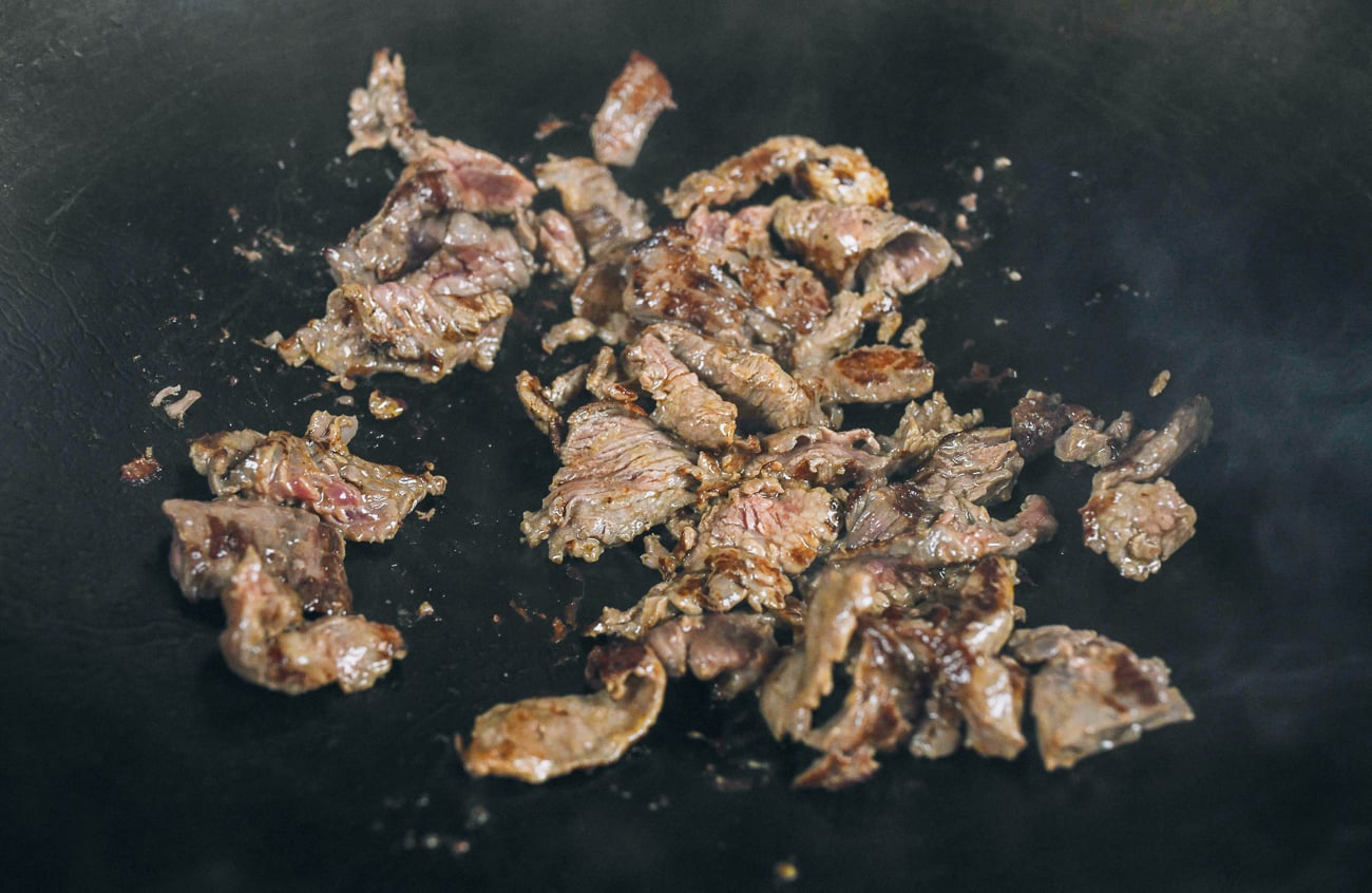 searing beef in wok