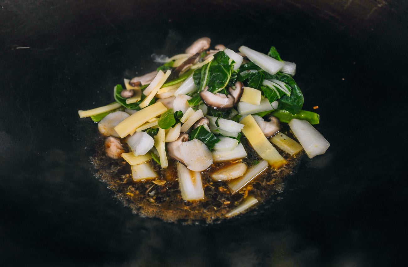blanched vegetables added to wok with sauce