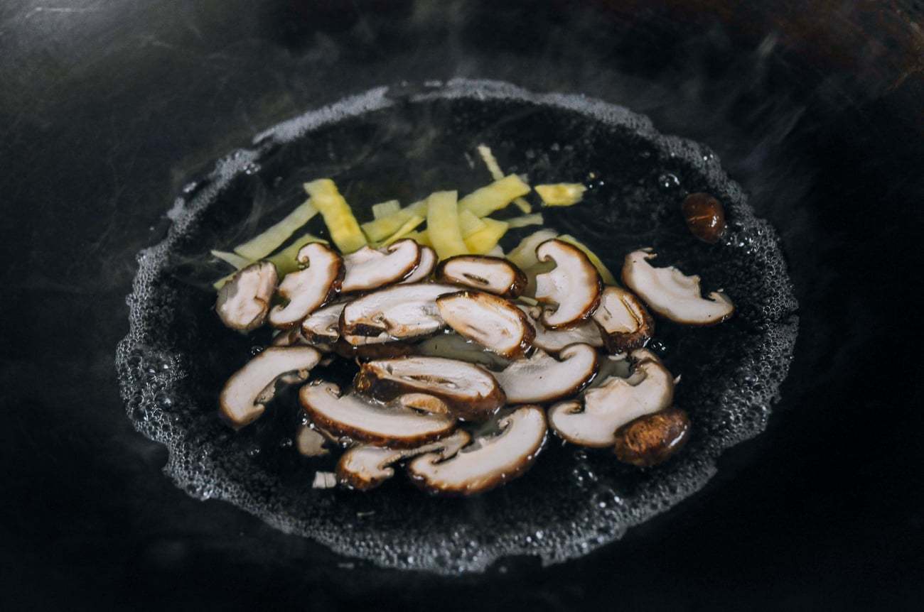 blanching vegetables in wok of simmering water