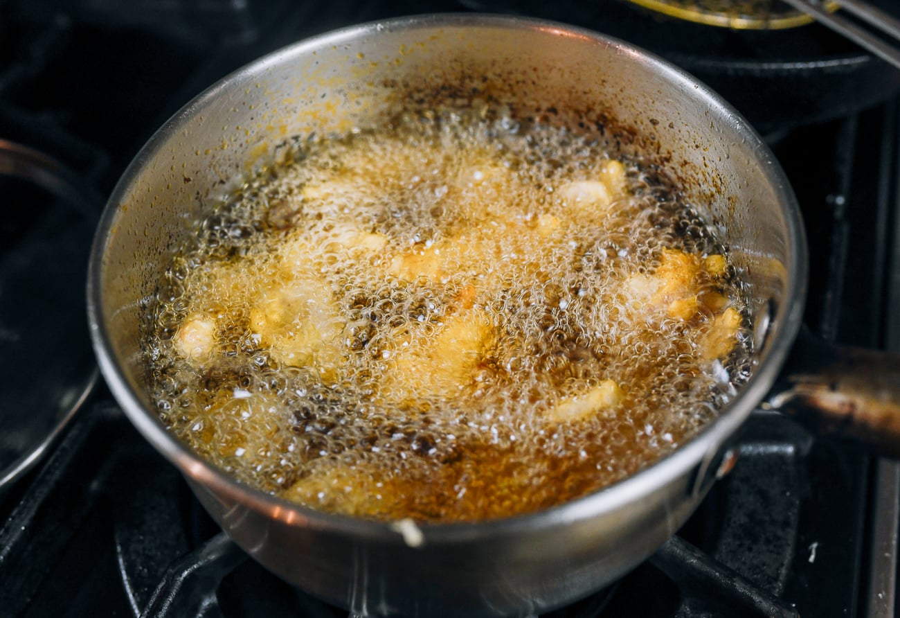 frying chicken chunks in a small deep pot