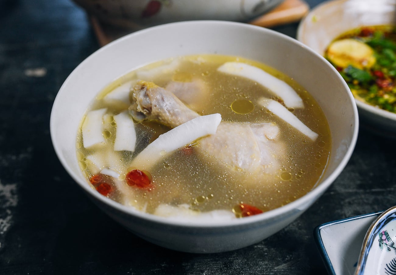 bowl of Hainan chicken soup with fresh coconut