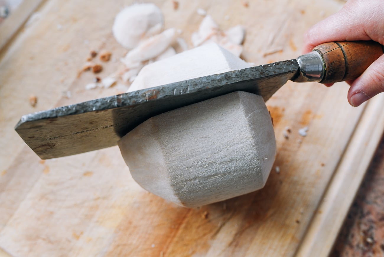 cutting young coconut in half