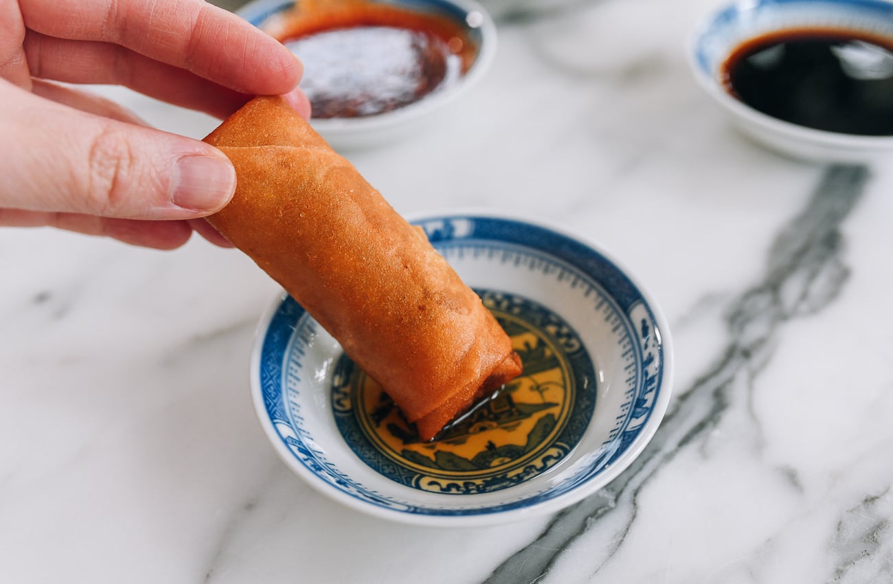 dipping spring roll into shanghai rice vinegar
