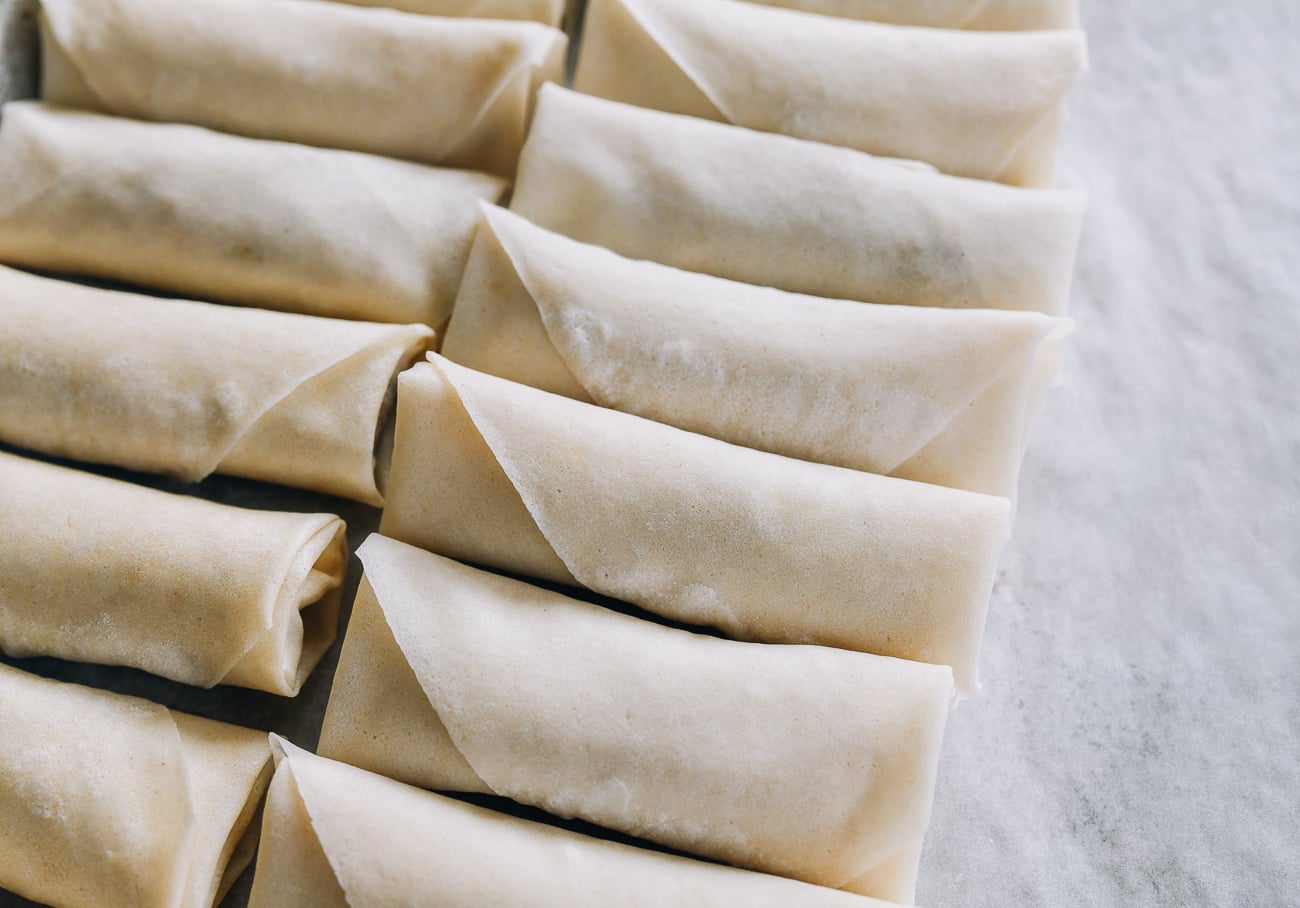 assembled spring rolls on baking sheet