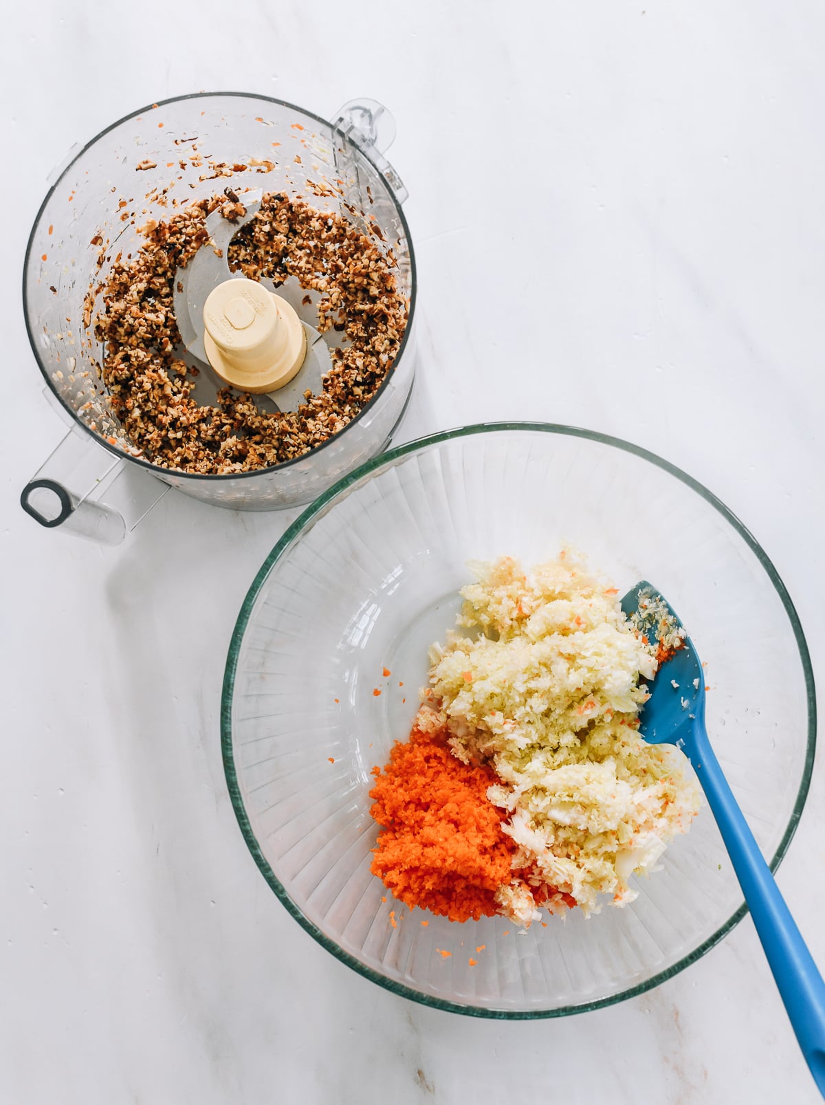 finely chopped dried shiitake mushrooms in food processor with bowl of chopped carrot and napa cabbage