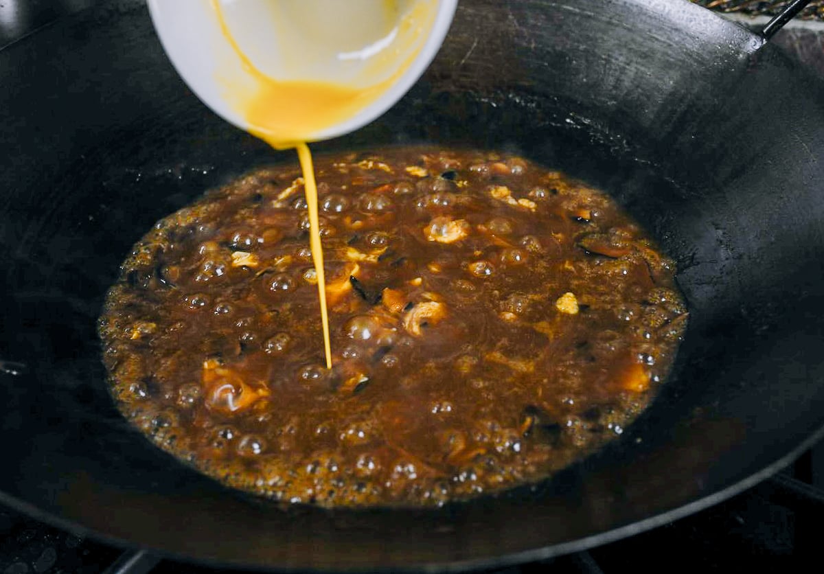 pouring beaten egg into Chinese gravy mixture
