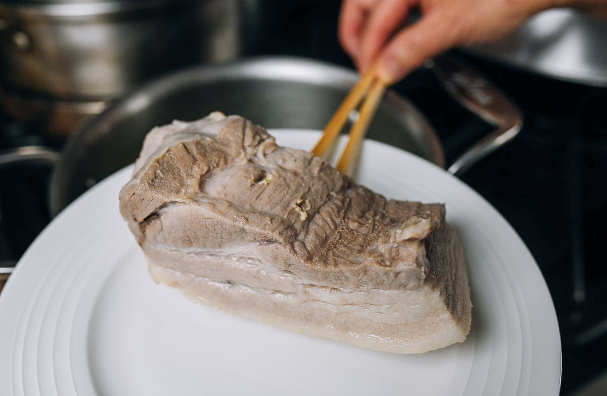poking pork belly with chopsticks