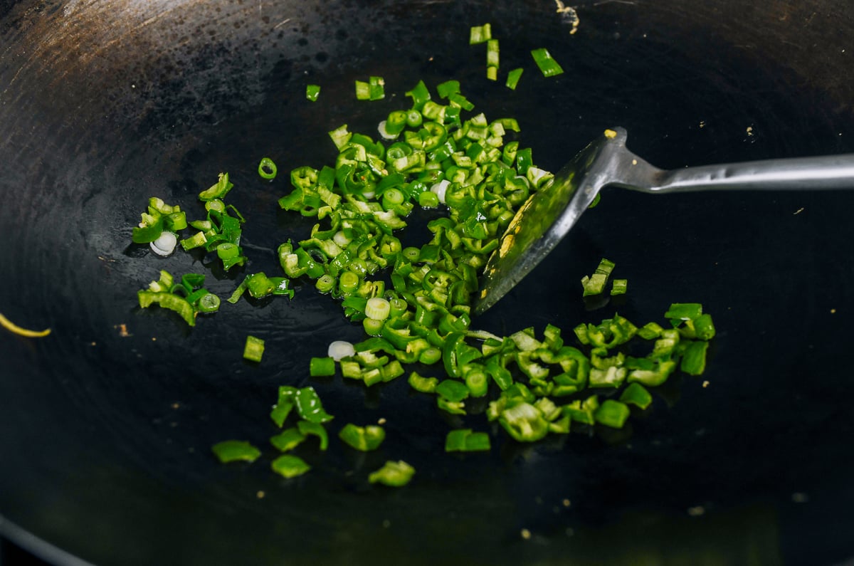 stir-frying peppers and scallions