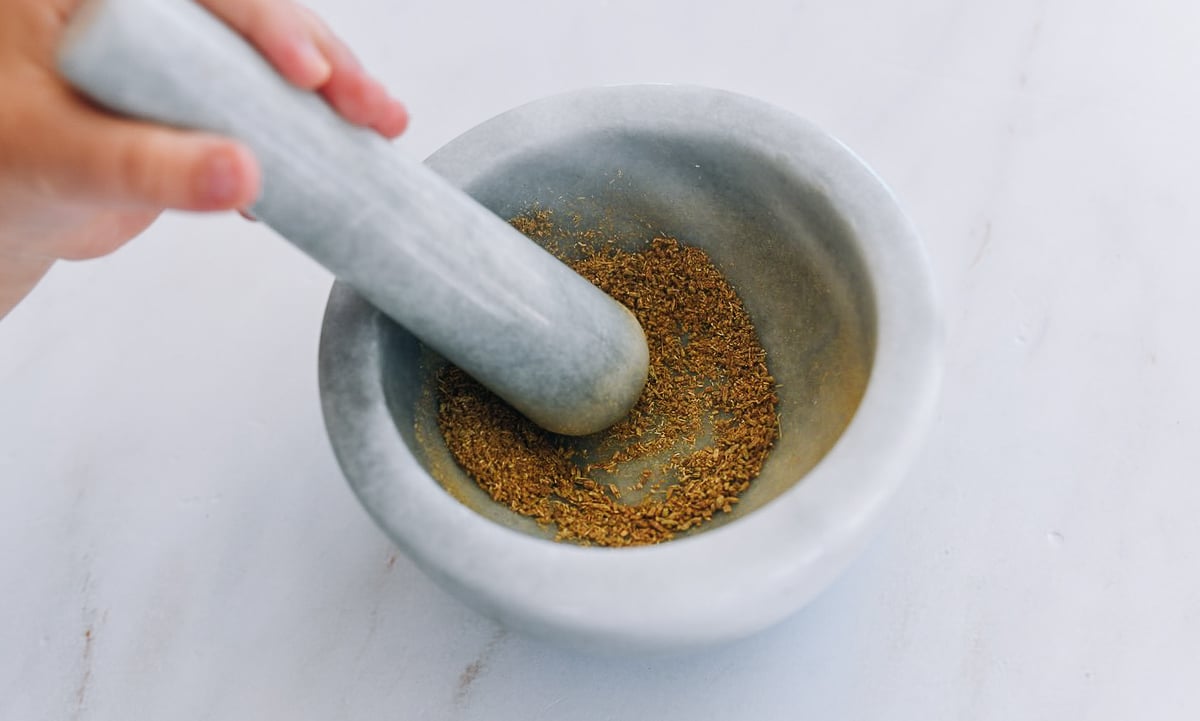 ground fennel seeds in mortar and pestle